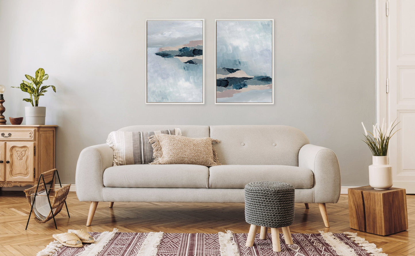 Living room with a beige sofa, wooden side table, and abstract wall art.
