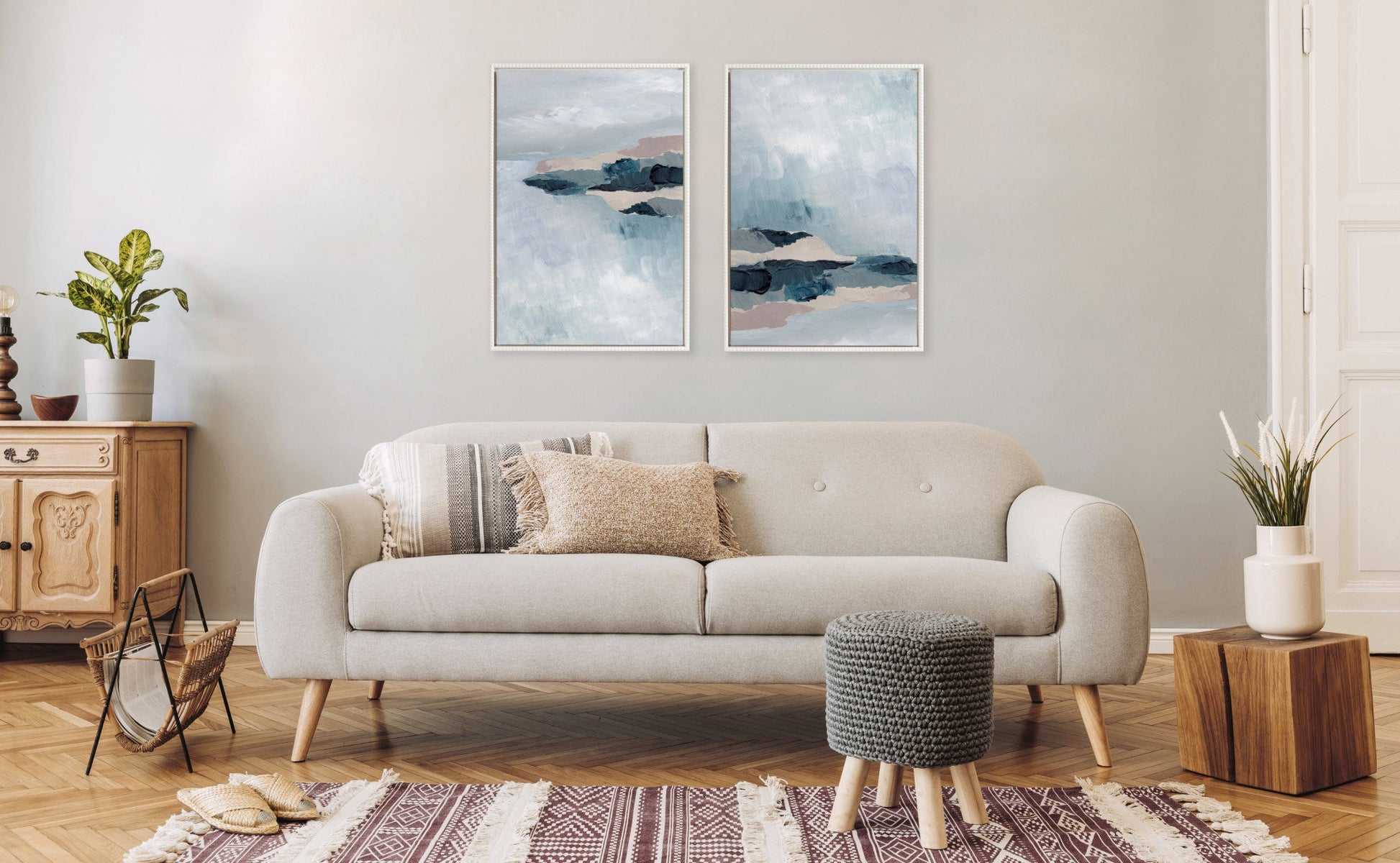 Living room with a beige sofa, wooden side table, and abstract wall art.